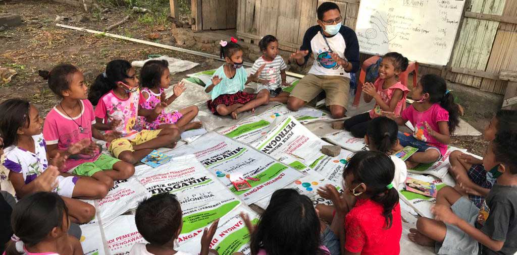 Volunteer interacting with students in a camp
