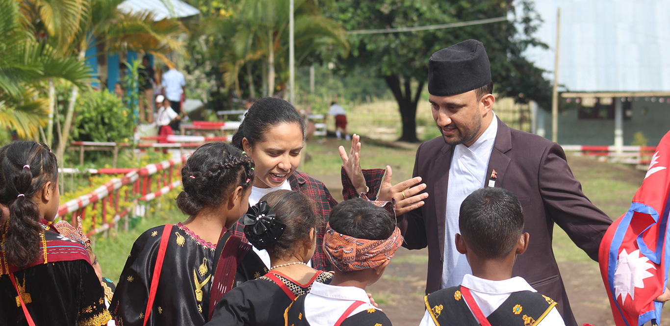 Volunteers interacting with school staff and students