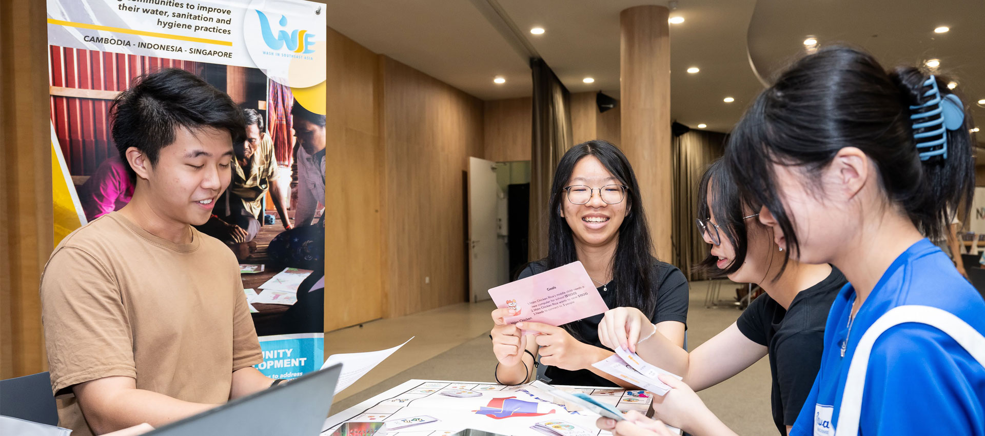 Volunteers playing a board game about saving money