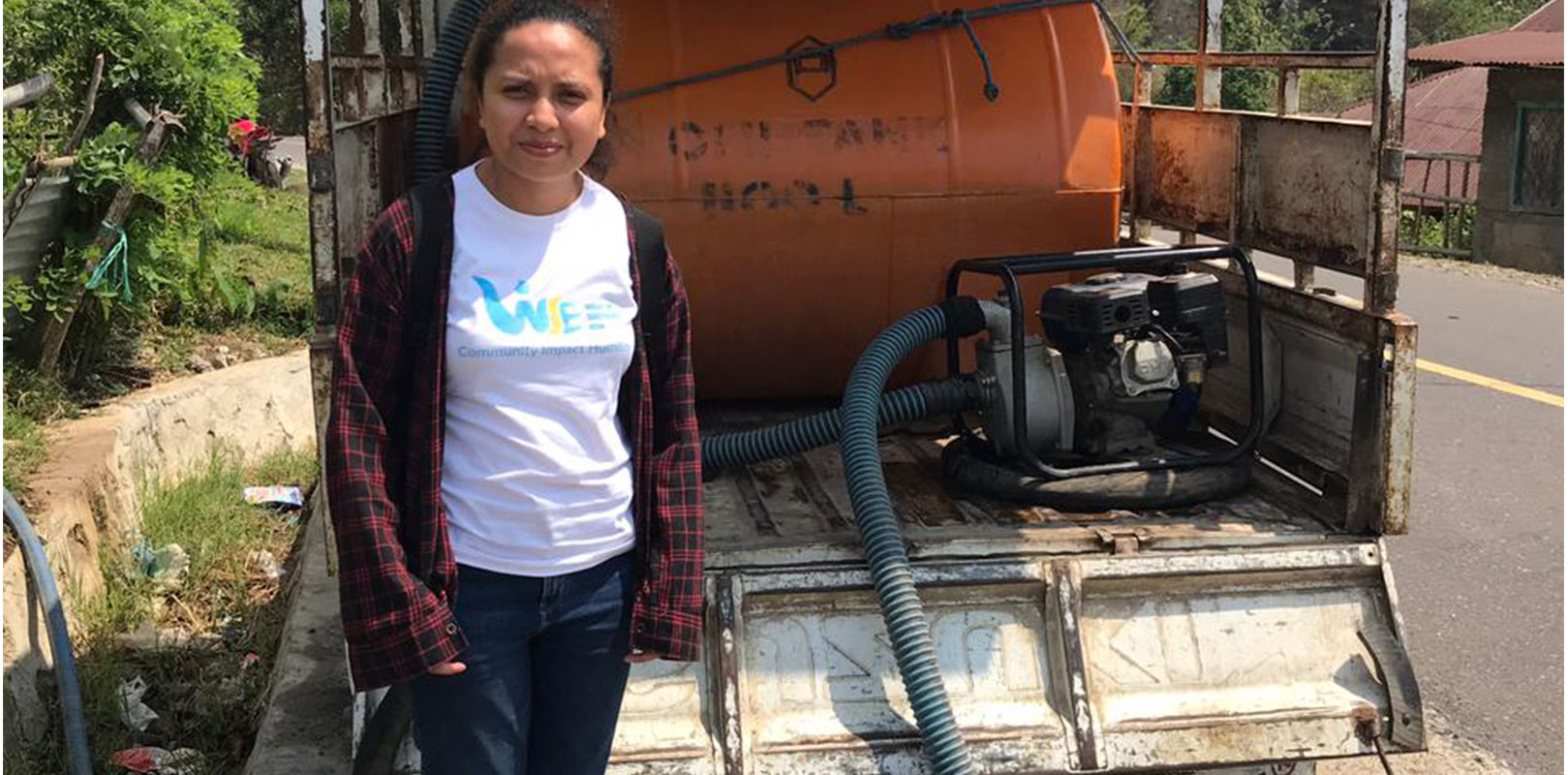 a volunteer posing for a photo with equipment