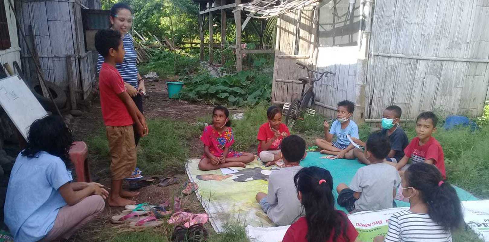 a volunteer interacting with students in english club