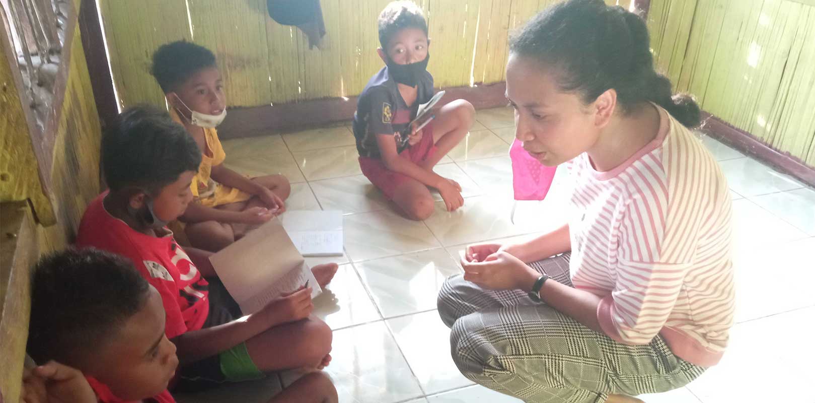 a volunteer interacting with students in english club