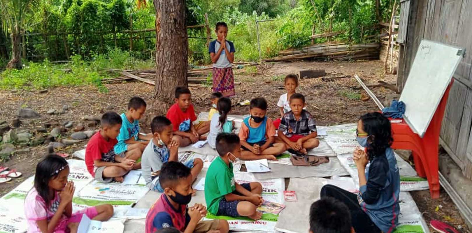 a volunteer interacting with students in english club
