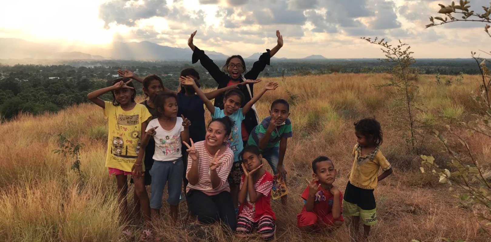 a volunteer and students posing for a photo in english club
