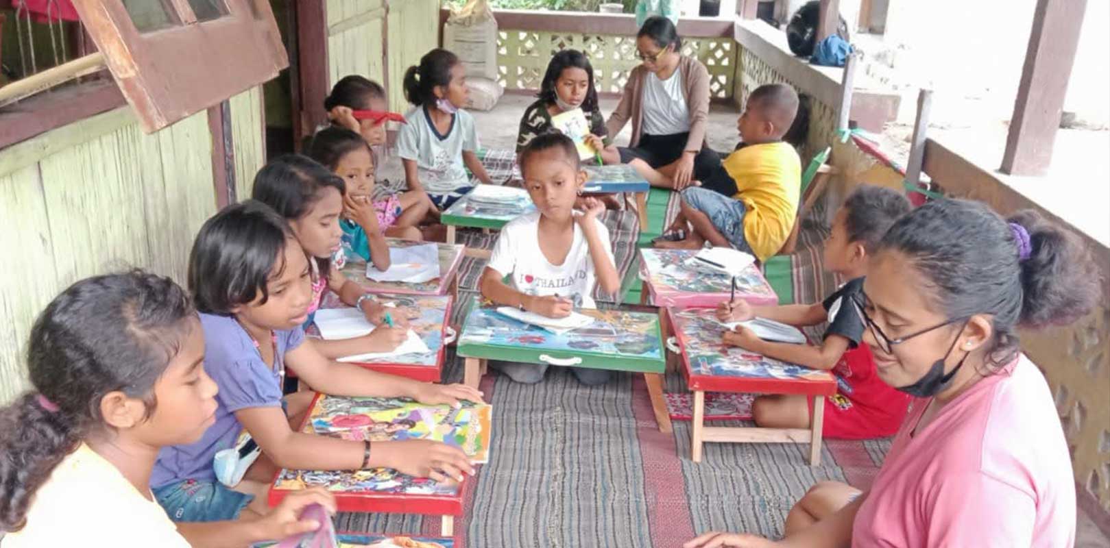 volunteers interacting with students in english club