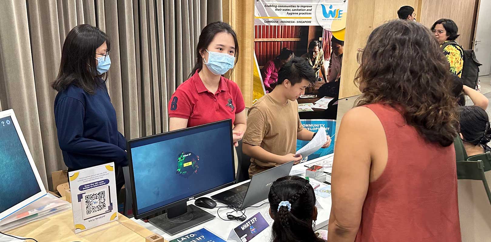 volunteers interacting with participants in a fair