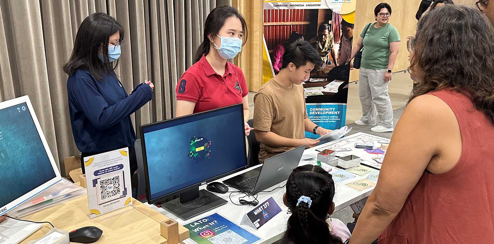 volunteers interacting with participants in a fair