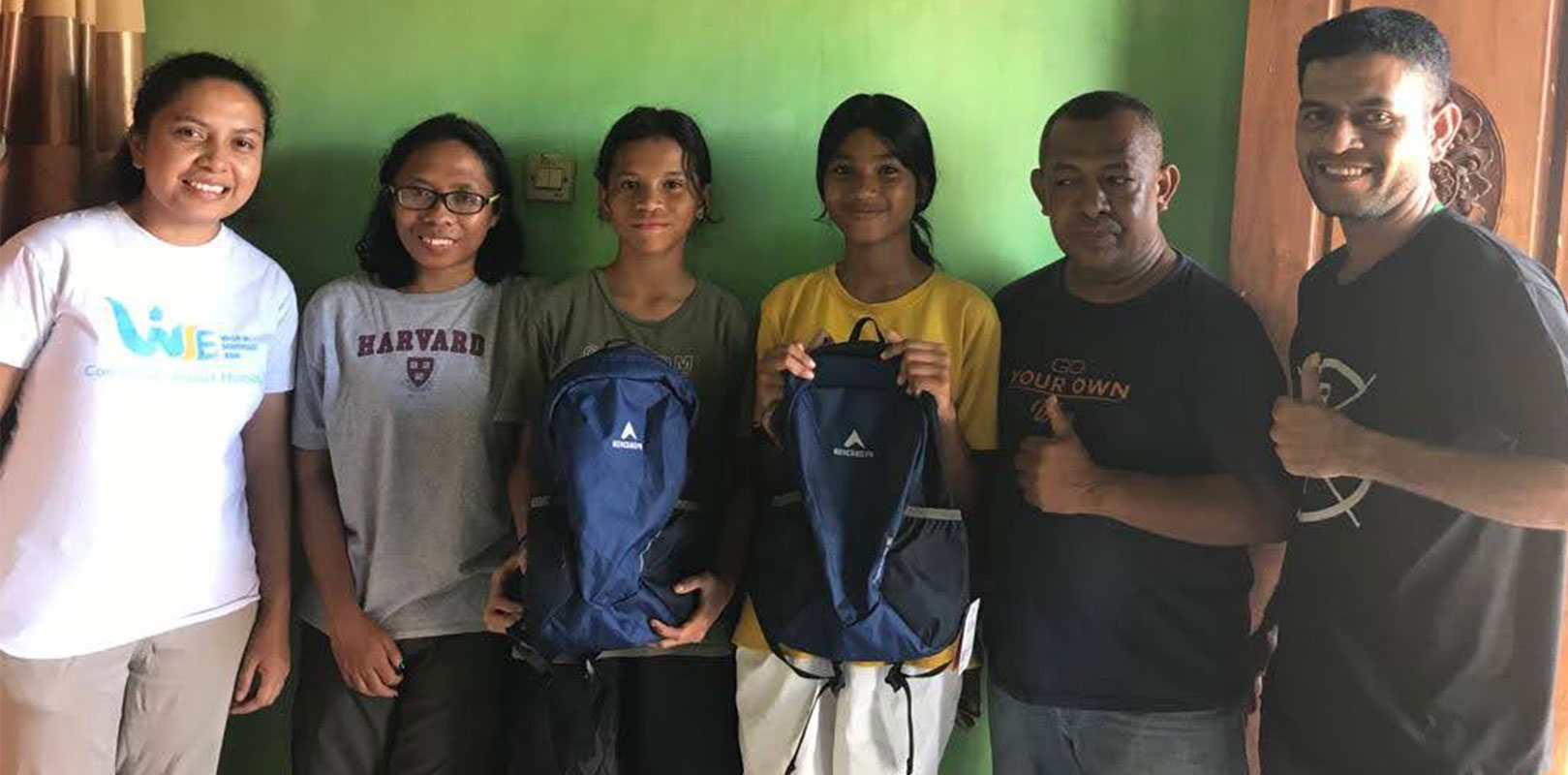 volunteers posing for a photo with recipients of kits