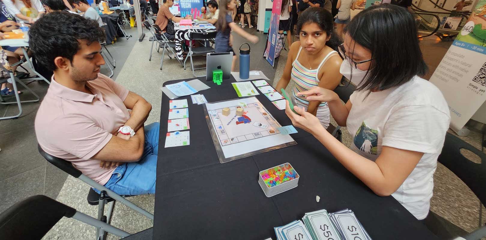 participants playing the board game, super saver