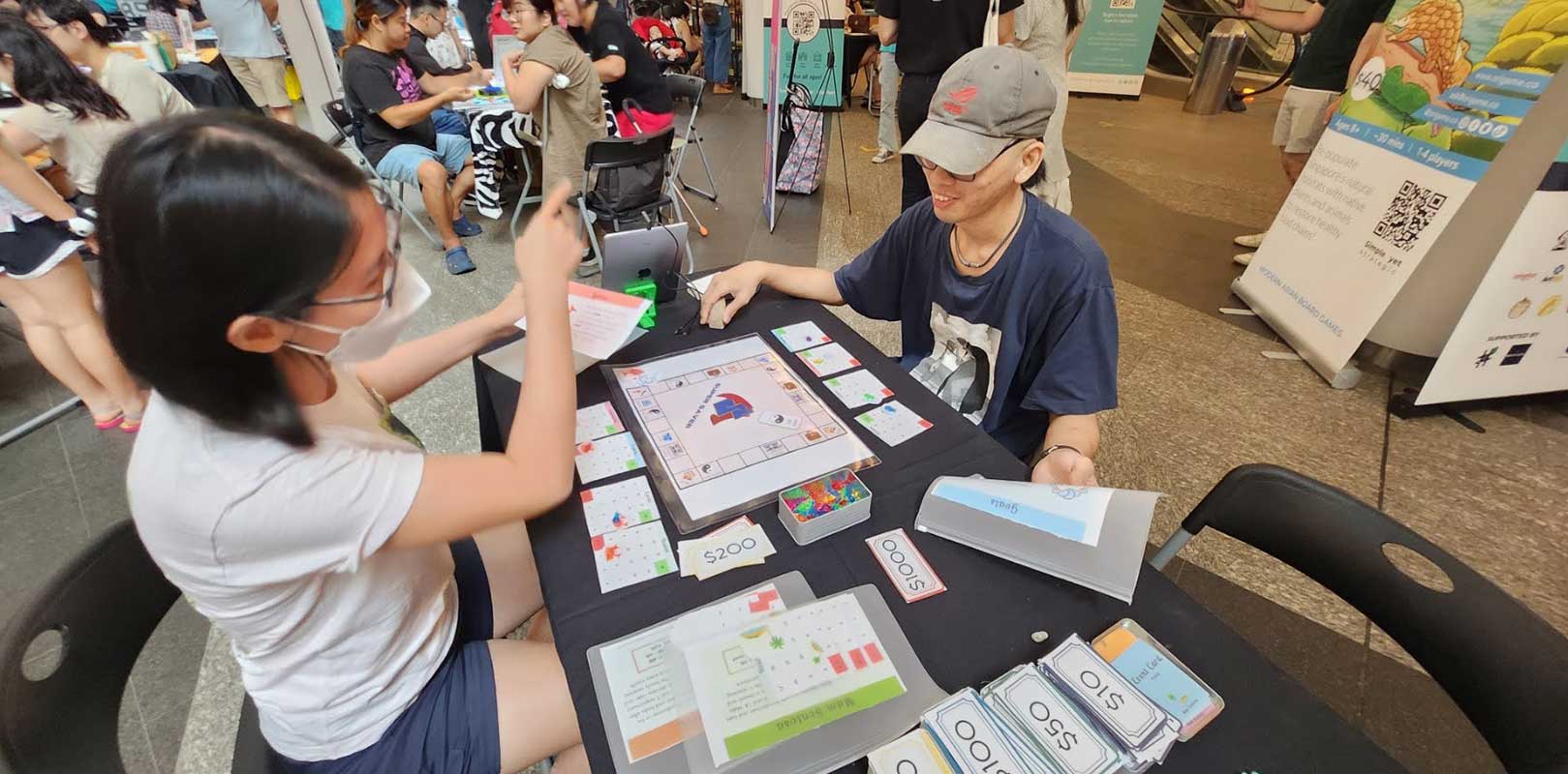 participants playing the board game, super saver